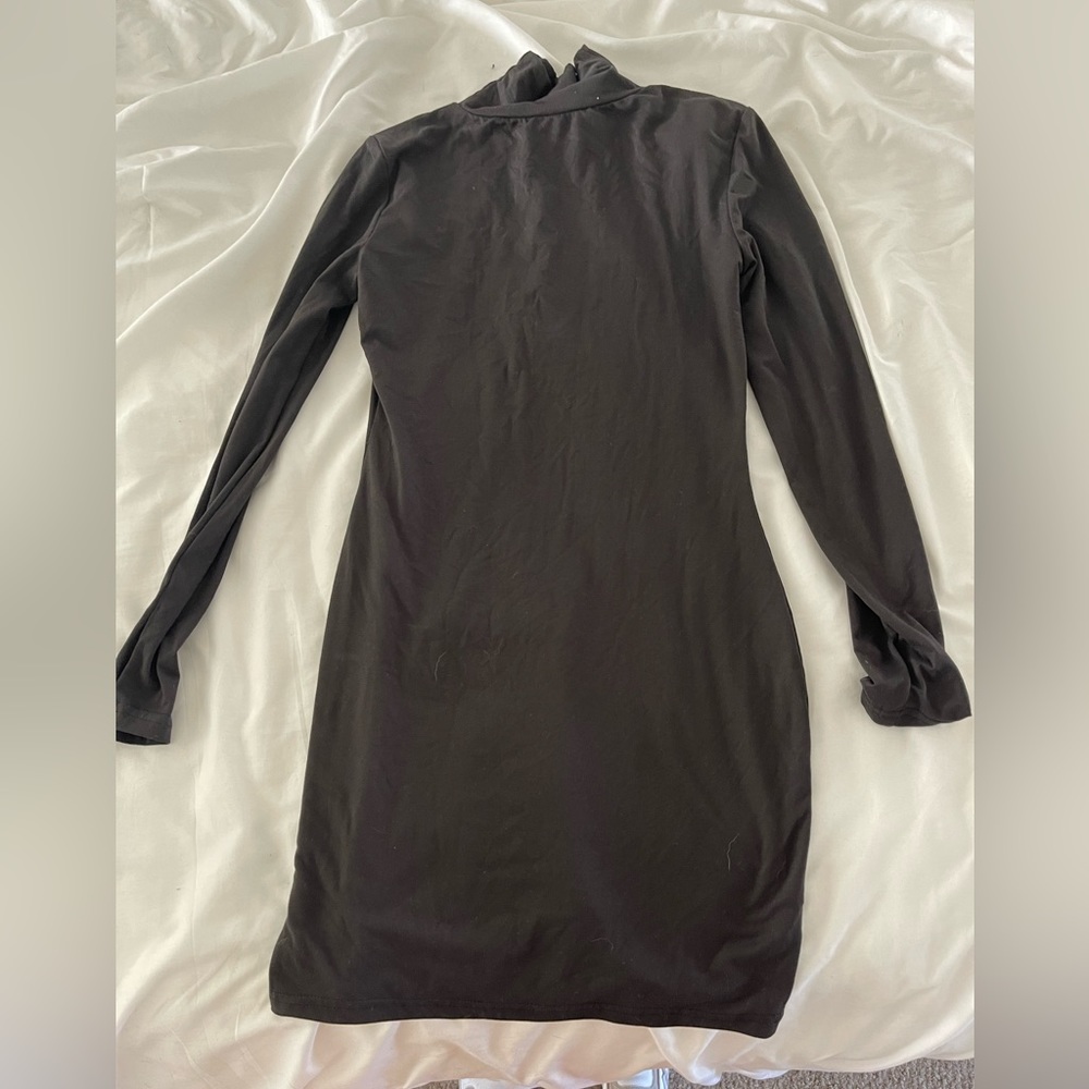 Tight black turtleneck dress